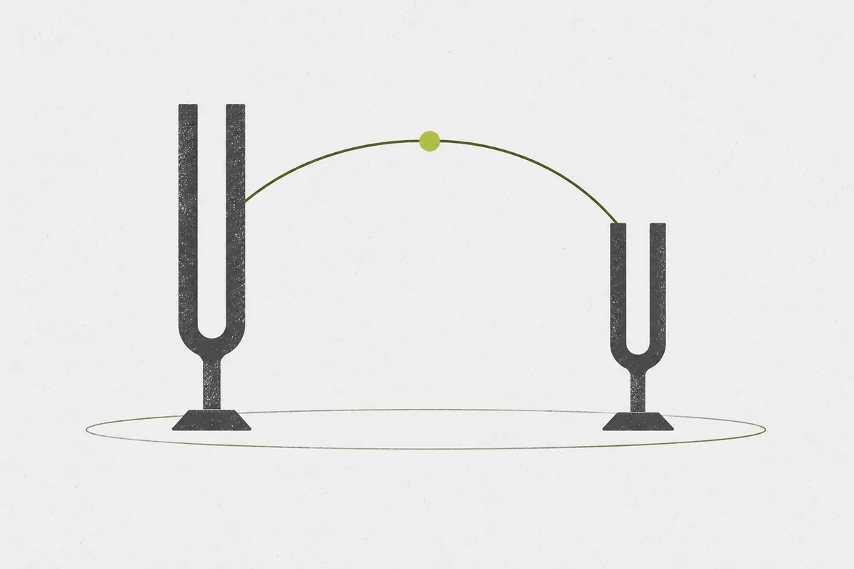 Two tuning forks of different sizes connected by a curved line over an open frame.