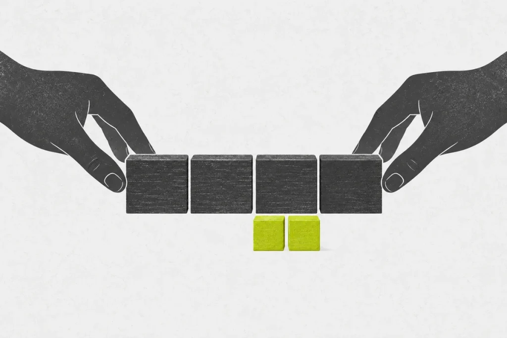 Two hands arranging four large practice blocks above two smaller subdivision blocks.
