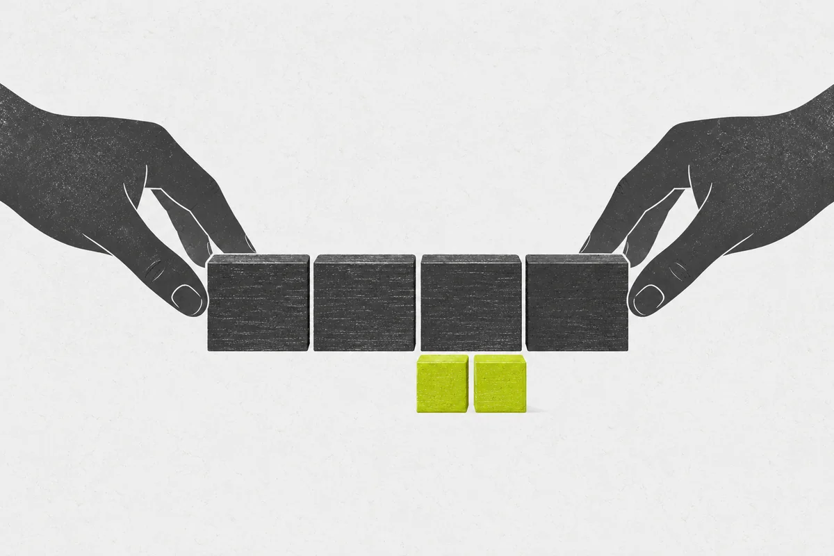 Two hands arranging four large practice blocks above two smaller subdivision blocks.