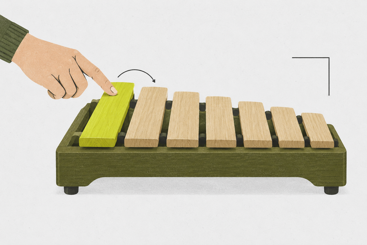 Seven unlabeled wooden tone bars arranged from long to short as a hand begins the sequence.
